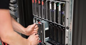 Computer Engineer Installing Blade Server In Data Center