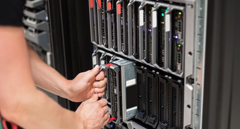 Computer Engineer Installing Blade Server In Data Center