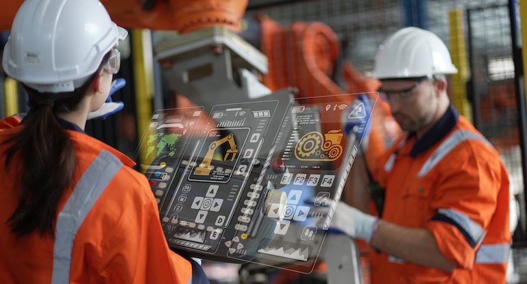 Engineer manager checking and controling automation robot arms machine