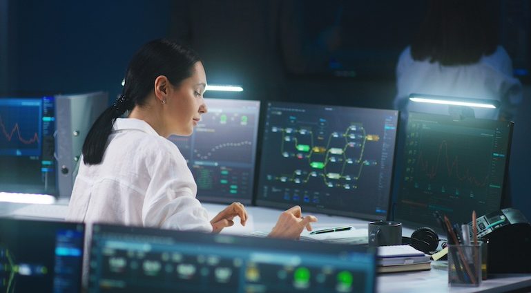 IT technical specialist works on computer with data server