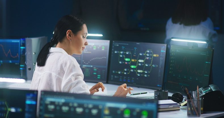 IT technical specialist works on computer with data server