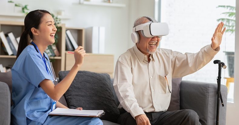 Happy senior man having fun with using VR enjoy at home