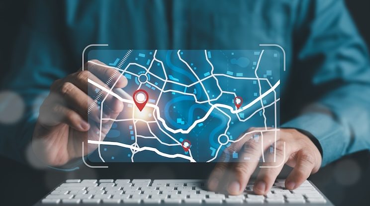 Businessman marking location pin points and search addresses on geolocation map application.