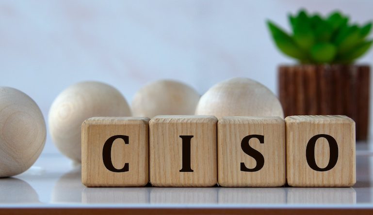 CISO - acronym on wooden cubes against the background of light balls and cactus
