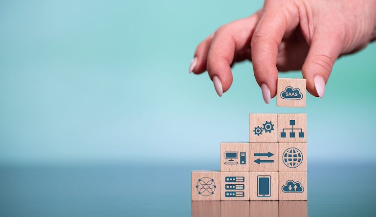 Concept of SaaS with icons on wooden cubes