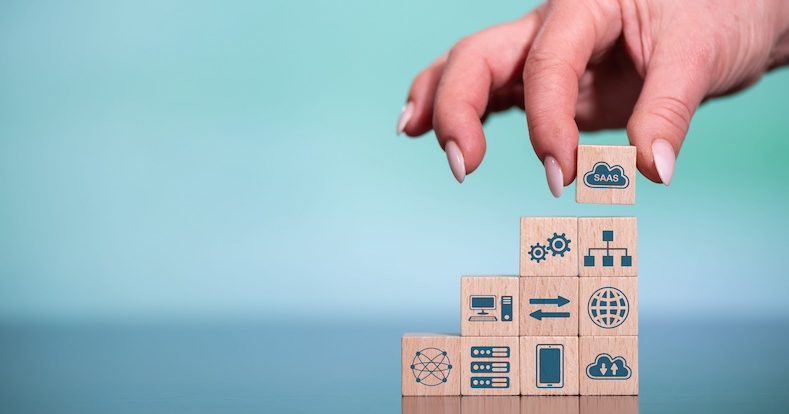 Concept of SaaS with icons on wooden cubes