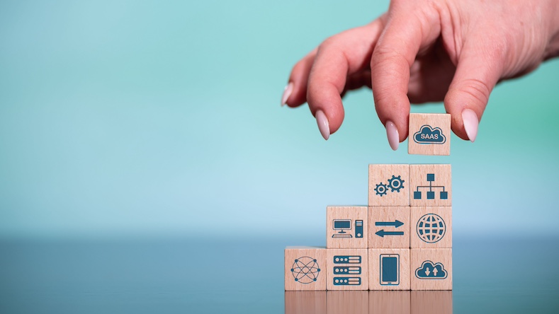 Concept of SaaS with icons on wooden cubes